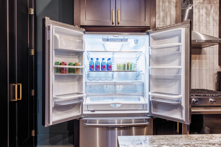 Fridge open with water bottles inside