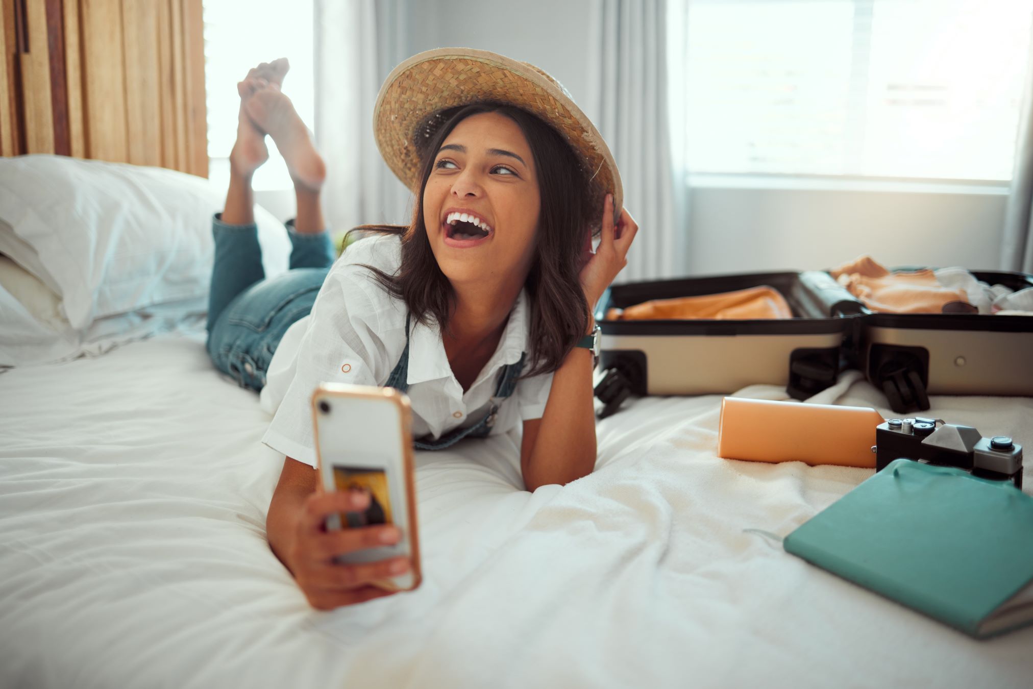 Girl on bed with luggage